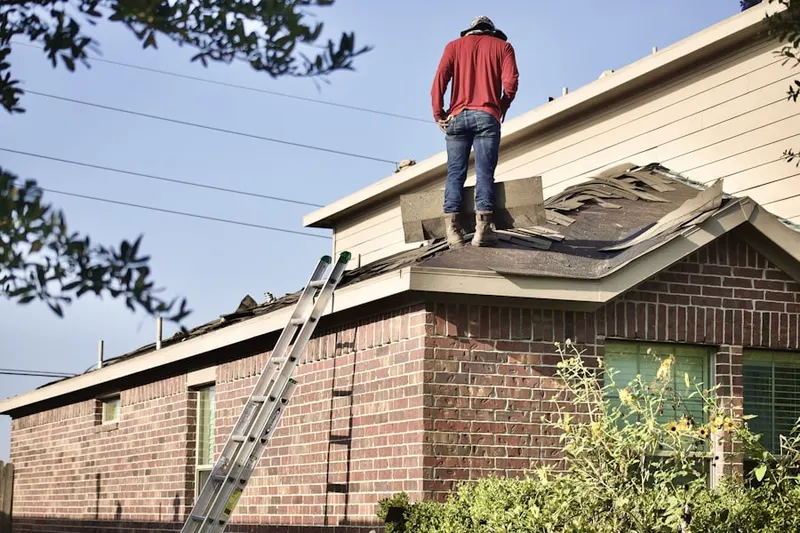 Professional roofer working on a residential roof in The Estates